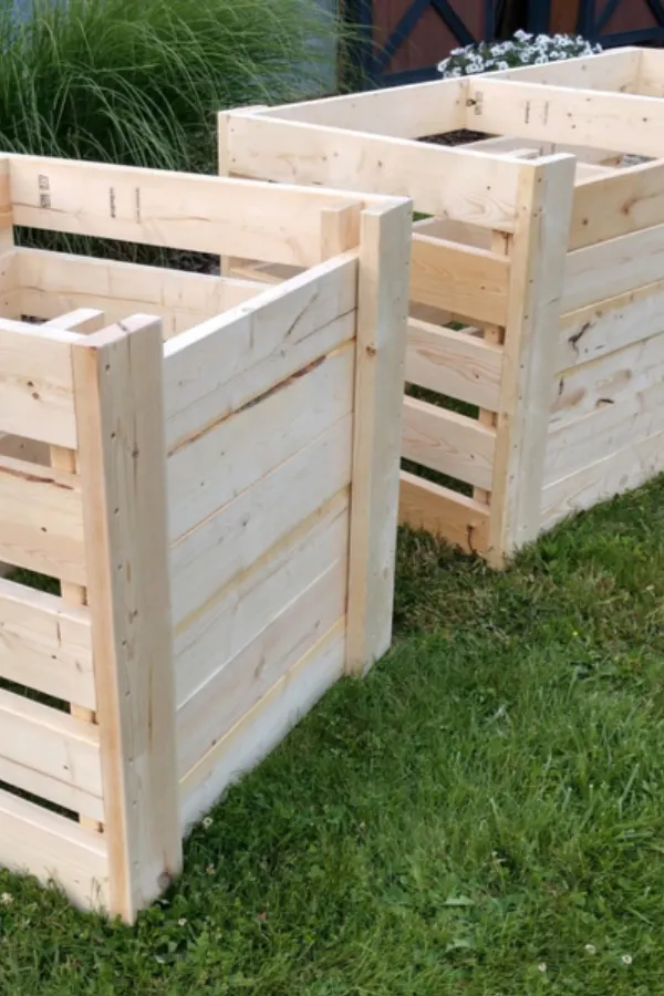 Two beautiful DIY wooden compost bins next to one another allow you to compost like a pro.