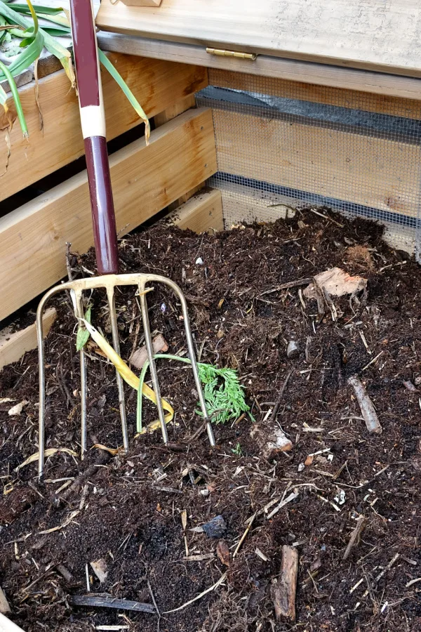 A compost pile with a pitchfork
