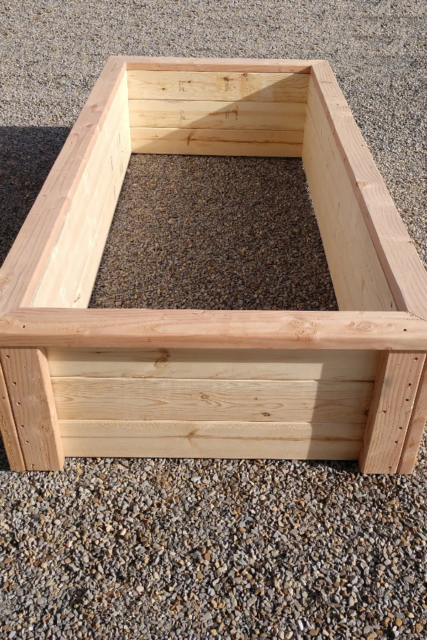 An empty wooden raised garden bed